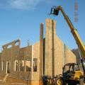 A crane is used to install the SIP fireplace chimney chase