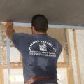 Install a foam gasket along top plates before installing drywall
