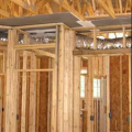 The drywall above the dropped ceiling duct chase extends beyond adjoining top plates for a continuous air barrier