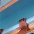 A second layer of rigid insulation is installed over the 2 in. by 4 in. retaining strip