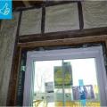 Right - New flashing has been installed to complete the air and water control layers at the window openings of this wall retrofit that includes insulating the wall cavities with spray foam