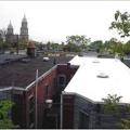 The white TPO membrane roof on the row house on the right performs extremely well at reflecting solar energy and maintaining cool surface temperatures while the black EPDM membrane roof on the left heats up rapidly in the sunlight