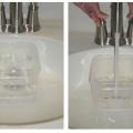 Testing the flow rate of a bathroom sink faucet.