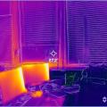 This infrared image shows little heat gain from north-facing double-pane windows with blinds, but significant heat output from computer monitors