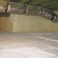 Right - Spray foam covers the walls and a sealed vapor retarder lines the floor of this unvented crawl space.