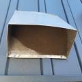 Wrong - Vent screening on outdoor air intake has been clogged with dirt and screen has been pulled up into vent and is no longer covering the entire opening.