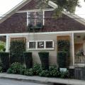 Vertical trellises and tall shrubs provide very effective shading to the east-facing wall of this home.
