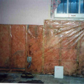 In warm-humid climates, do not install Class 1 vapor retarders on the interior side of air-permeable insulation in above-grade walls, except at shower and tub walls.