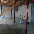 Right - Rigid foam insulation is taped at seams and installed over a drainage pad of aggregate to serve as a capillary break under the basement slab.