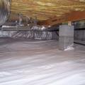 Polyethylene completely covers the floor of this crawlspace and is attached to the walls and piers as well