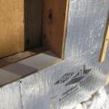 A piece of siding is used as sill extension and to provide slope in the opening for the window, which is deeper because exterior rigid foam has been added