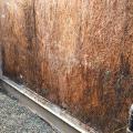 The sheathing has rotted because there was not a sufficient drainage gap behind the stucco cladding