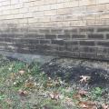Staining and the absence of flashing at the base of an exterior brick wall