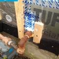 Right - The pipe penetration is properly flashed and furring strips are installed on each side in preparation for installing cladding
