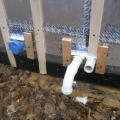Duct/pipe penetration with metal cap flashing and wood blocking for trim attachment
