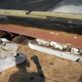 Closed-cell spray foam fills the roof joist cavities forming an air barrier between the masonry parapet wall and the roof sheathing