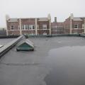 The existing flat roof before removal of membrane shows lack of slope allowing water to pool on the surface