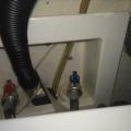 The condensate line (amber-colored plastic tube) from the high-efficiency furnace drains into the sewer via the same drain pipe as the clothes washer