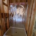 Wrong - Wall cavities behind shower are not completely filled with insulation and are lacking the solid interior air barrier. 