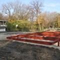 To handle the high water table on this lot, the builder installed underground drain pipe to french drains for slow dispersal of storm runoff, then set the floor joists on steel framing set 4 ft above grade on 35-foot-deep piers.