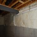 Wrong - The fiberglass blanket insulation has no perforated vapor retarder, does not cover the entire basement wall, is not sealed at the edges, and is not installed over rigid foam.