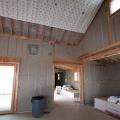 Sheets of phase-change material are installed over the cellulose insulation to help even out interior temperatures.