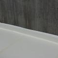 Four inches of rigid foam separate the concrete slab from the ground and the foundation walls. 