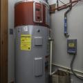 Right - This 80-gallon heat pump water heater is ducted to pull heat from outside air drawn from the south side of the house and to exhaust cooled air outside on the north side of the house to efficiently heat water without impacting room temperatures.