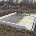 The basement slab is wrapped in a blanket of insulation including R-27 of closed-cell spray foam under the slab and R-22 ICF blocks wrapping the slab edges.
