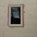 Before installing the windows, the window rough openings are sealed with a liquid-applied flashing that provides a seamless moisture and air barrier to protect the wall from water intrusion.