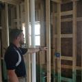 Installing ladder blocking at interior-exterior wall intersections rather than three solid studs in the exterior wall as the supporting surface allows room for insulation in the exterior wall.