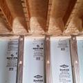 The rim band connecting the insulated precast concrete basement walls to the floor joists above is spray foamed to provide air-sealing and insulation in this hard-to-seal juncture.