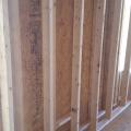 The exterior walls are double walls consisting of two 2x4 stud walls set 3 inches apart to form a 10-inch-thick wall cavity that is filled with blown-in fiberglass to provide a continuous R-40 blanket of insulation around the home. 