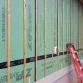 Furring strips provide a ventilation gap between the coated OSB sheathing and the fiber cement siding.