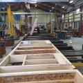 These factory-built walls consist of 9.5-inch I-studs sheathed with coated OSB, faced with OSB, and dense-packed with cellulose; a second interior surface of drywall is added to provide a 1.5-inch cavity for electrical wiring.