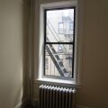 The exposed riser shown here also supplies the radiator. A short pipe runs under the floor to the hand valve. 