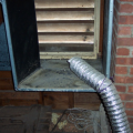Wrong - Terminate exhaust fan ducts outdoors, not "near" the outdoors