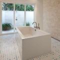 An outdoor shower off the master bathroom keeps heat and humidity outside for this hot-humid climate home.