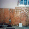 Wrong - Do not install a Class I vapor retarder over vapor-permeable insulation on the interior of a foundation wall because the vapor retarder can trap moisture in the wall, which can lead to mold.