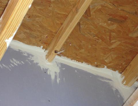 Fire-rated sealants or a fire-rated assembly air seal the tops and bottoms of the demising walls between two units in a multifamily building