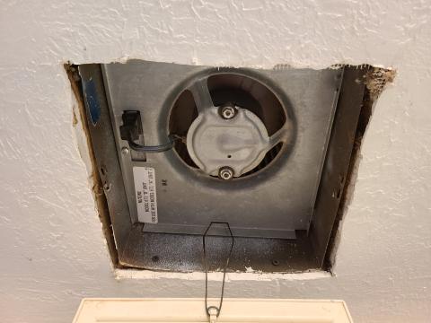 The jagged edges of the cutout around this ceiling exhaust fan require canned spray foam, metal tape, or fiberglass mesh tape and mastic to air seal the gaps and keep conditioned air from the home from escaping into the attic