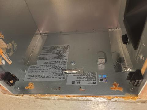 The fan was removed from this exhaust fan box to access and air seal the seams with metal tape and the holes in the housing with canned spray foam