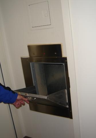 Vertical service shafts and trash chutes are isolated from corridors in multistory buildings by locating them within the vestibules