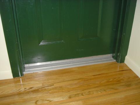 Doors to individual units in a multifamily building are separated from corridors using weatherstripping and airtight door sweeps.