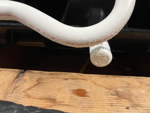 Condensation droplets are clearly seen on this uninsulated condensate line from an air conditioner located in a hot humid attic.