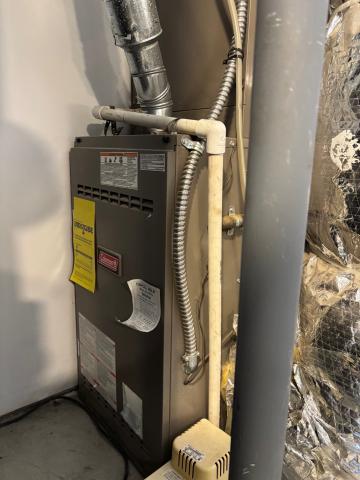 This is an ambient atmospheric-combustion furnace that pulls its combustion air from the room or space in which it is located in through an open grill on the front of the combustion chamber.