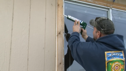 Apply caulk to the tops and sides when installing an exterior storm window. Do not caulk the bottom.