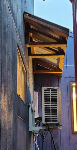 A permanent awning prevents snow and overflowing ice dams from causing damage to HVAC equipment below.