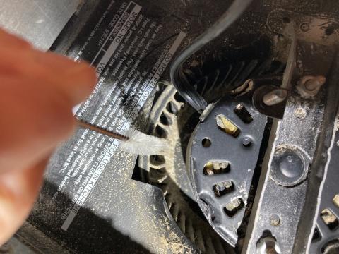 This narrow bottle brush was an effective tool for removing the debris between the blades of this bathroom exhaust fan