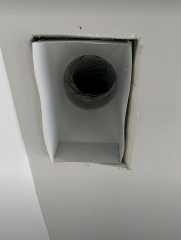 With the register grill removed, very large gaps are visible around the edges of this duct boot between the duct boot and the drywall; the gaps can be closed with screw or heavy staples then sealed with caulk, mastic, or metal tape.